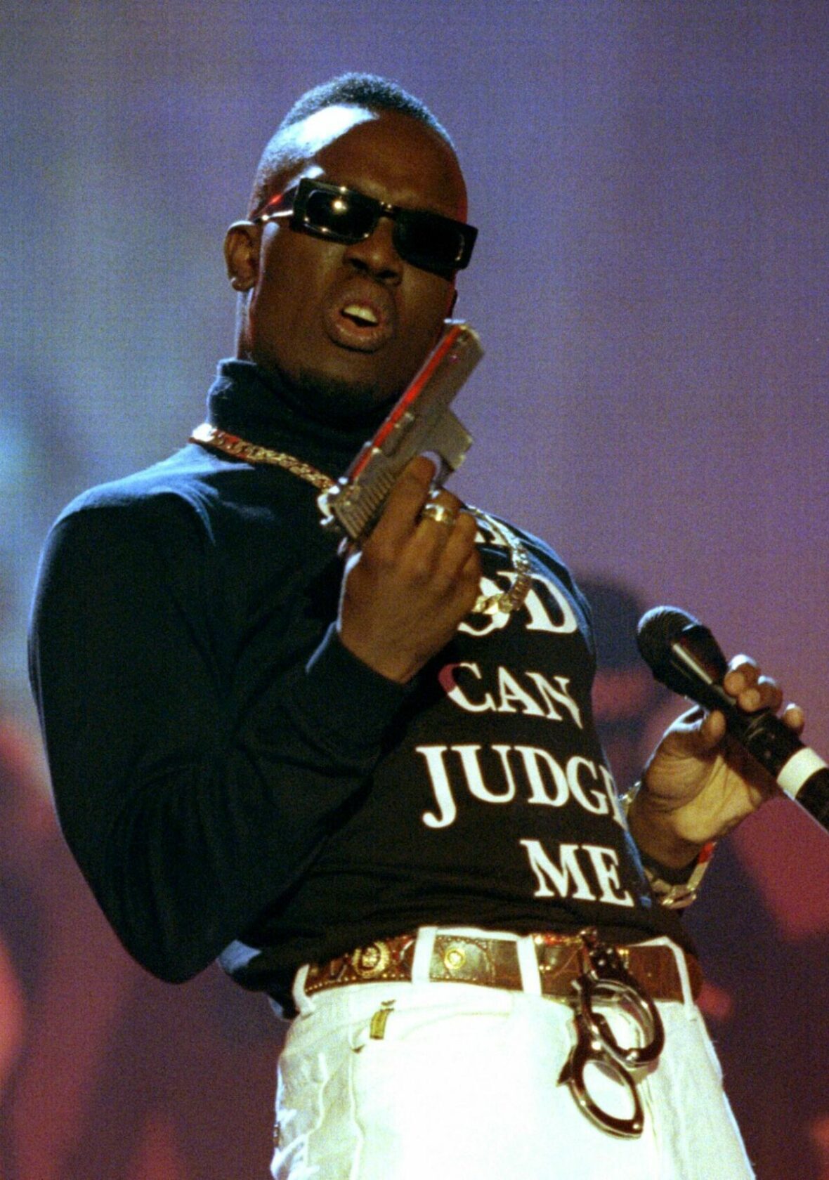 British rap artist Mark Morrison performs with a fake gun and a shirt reading 'Only god can judge me..
